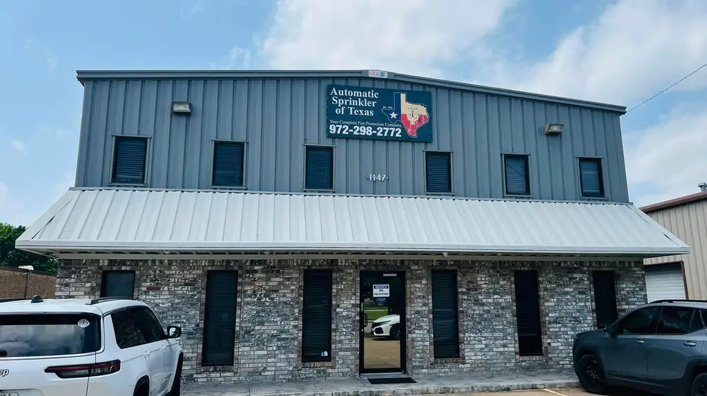 Automatic Sprinkler of Texas building at 1147 South Cedar Ridge Drive in Duncanville, with the company sign reading Est. 1995